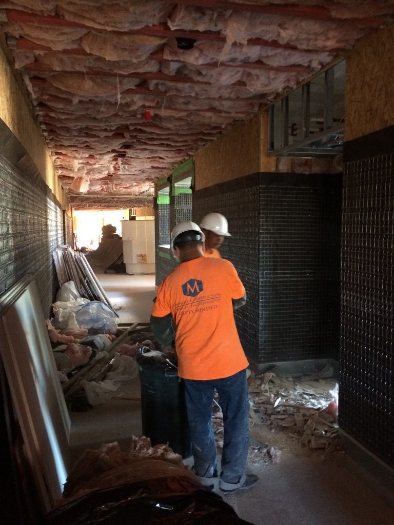 Maynard CSI crew cleaning an active construction corridor