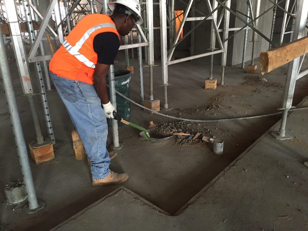 Crew removing debris under scaffolding